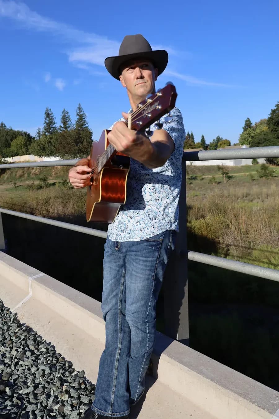 Shawn Wrangler playing guitar outdoors